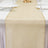 Elegant ivory sheer table runner with gold trim on a white dining table.