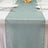 Mint green sheer table runner on a white dining table with elegant tableware