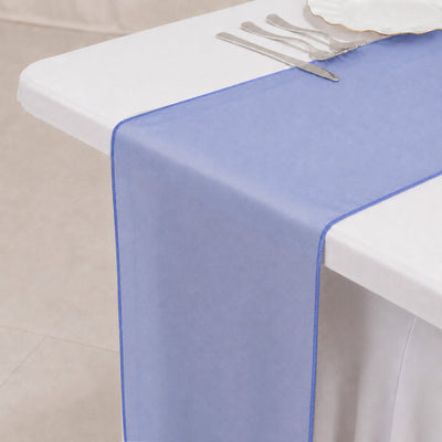 Blue sheer table runner on white tablecloth with silver cutlery 