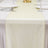 Cream satin table runner on a white elegant dining table setting