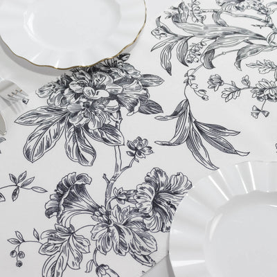 Black and white floral patterned tablecloth with elegant plates