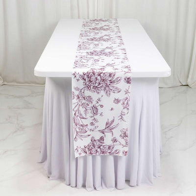 White table runner with mauve floral pattern on draped banquet table