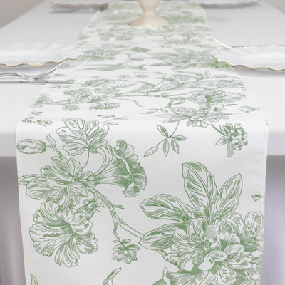 Green floral table runner on a white table setting.
