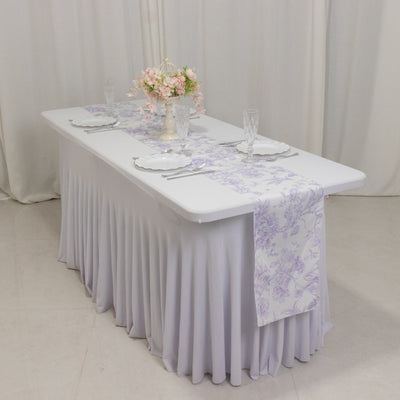 Elegant table setting with floral runner and centerpiece.