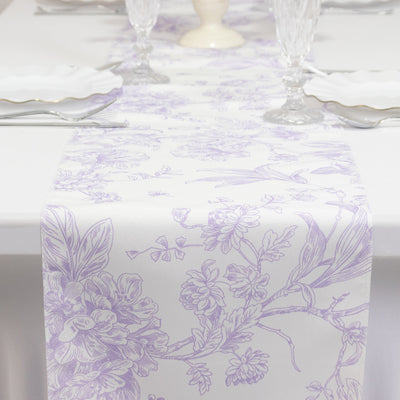 Floral patterned table runner in lavender and white on a dining table.