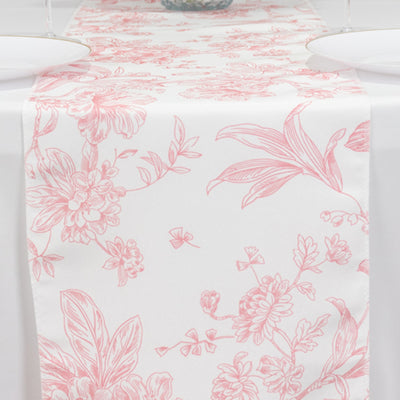 Floral patterned table runner in pink and white on a dining table