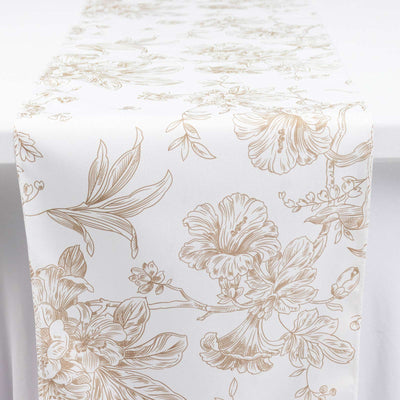 White floral table runner with gold botanical pattern on a table