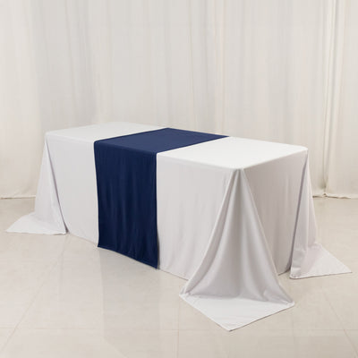 White table with navy runner on a plain backdrop