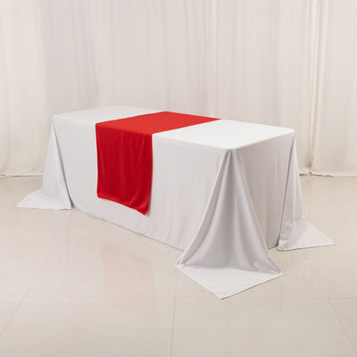 White table with red runner in studio setting
