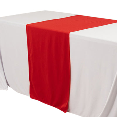 Red table runner on a white tablecloth