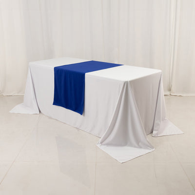 White table with blue runner on a clean backdrop.