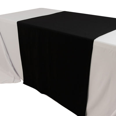 Black table runner on a white tablecloth for elegant dining decor.