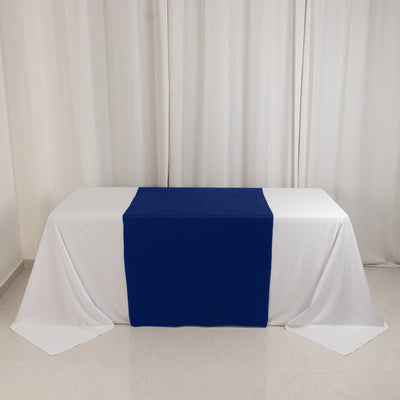 Blue table runner on a white tablecloth in a simple setting.