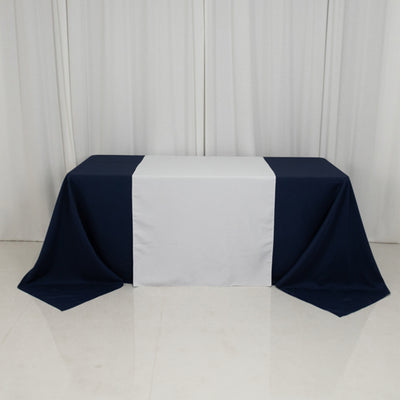 Navy and white tablecloth on a table in a studio setting