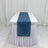 Blue table runner on a white tablecloth.
