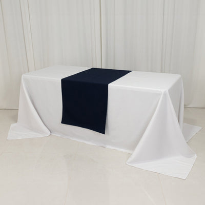 White table with navy table runner on a plain backdrop.
