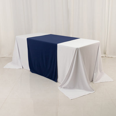 Table covered with navy and white drapes in a studio setting.