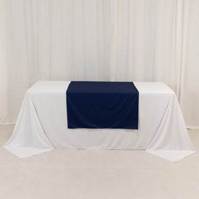 Navy table runner on a white tablecloth in a studio setting