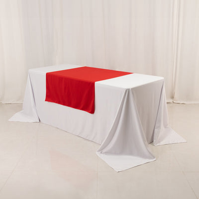 White table with red tablecloth in a studio setting