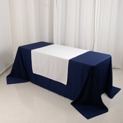 Navy blue and white tablecloth on a table in a studio setting