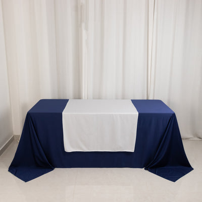 Navy and white tablecloth set on a table in a studio setting