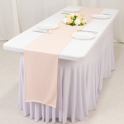 Elegant table setting with a pink runner and floral centerpiece.