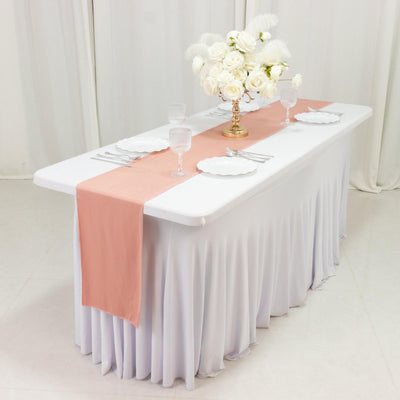 Elegant table setting with pink runner and floral centerpiece.
