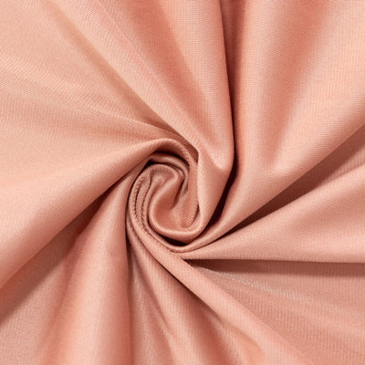 Peach fabric texture with a smooth, swirling design.