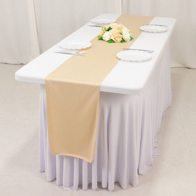 Elegant table setting with a beige runner and floral centerpiece.