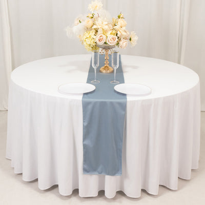 Elegant round table set with floral centerpiece and table runner.
