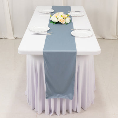 Elegant gray table runner on a white table setting with floral centerpiece.