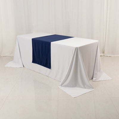 White table with navy runner in a studio setting