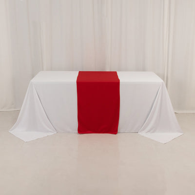 White table with a red runner draped over it
