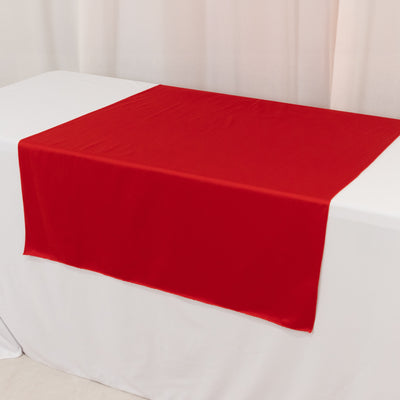Red tablecloth draped elegantly on a white table.