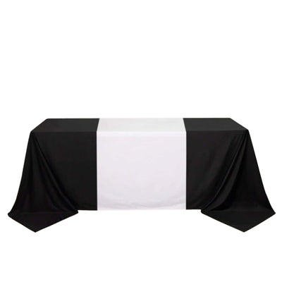 Black and white tablecloth on a plain backdrop