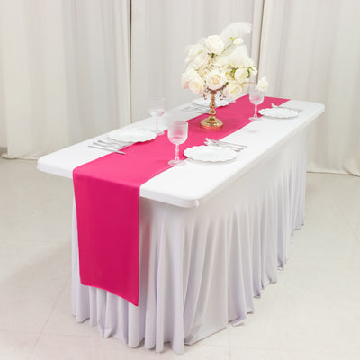 Elegant table setting with pink runner and floral centerpiece.
