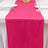 Bright pink table runner on an elegant dining table setting.