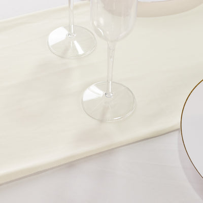 Elegant table setting with champagne flutes and a white table runner.