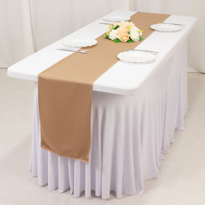 Elegant table setup with a beige runner and floral centerpiece.