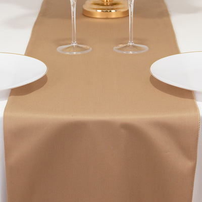 Elegant beige table runner on a dining table with white plates and glasses.