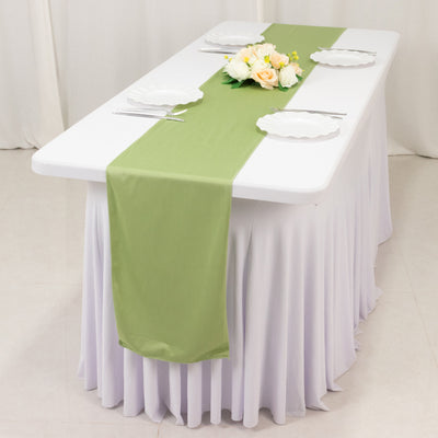 Elegant green table runner on a white table with floral centerpiece.