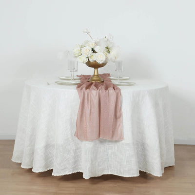 Elegant table setting with floral centerpiece and pink table runner.