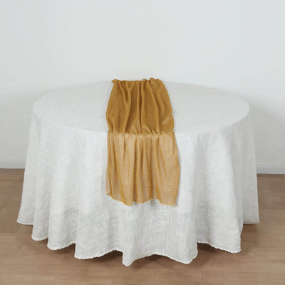 Gold shimmer scarf draped on a white tablecloth