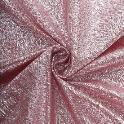 Shimmering pink fabric with a textured surface detail.