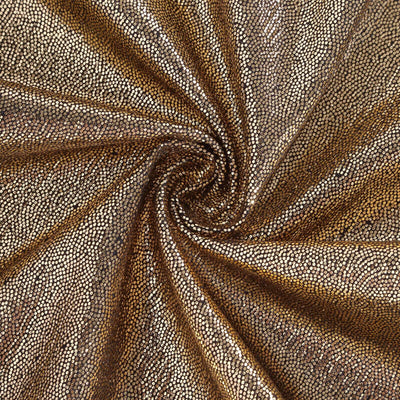 Textured gold and bronze fabric in a swirling pattern.