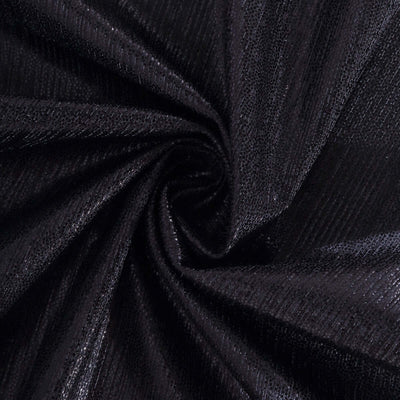 Black textured fabric swirl close-up, showcasing intricate patterns and sheen.