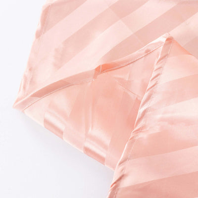 Peach satin fabric with subtle striped texture