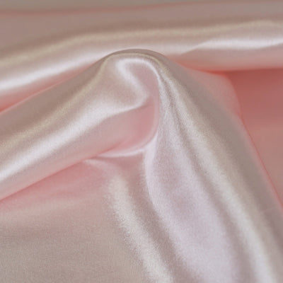 Pink satin fabric with a smooth, glossy finish.