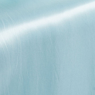 Light blue silk fabric texture close-up shot.