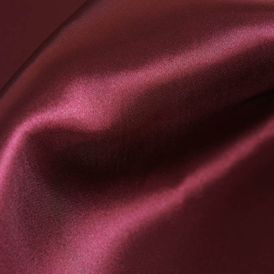 Burgundy satin fabric with a smooth texture and subtle sheen.
